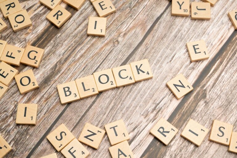 scrabble tiles spelling block words on a wooden surface